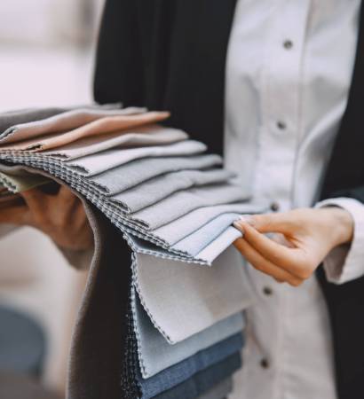 Sampler of fabric colors. The woman watches the colors and patterns of upholstery fabrics.