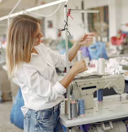 Woman with a thread. Lady in the factory.